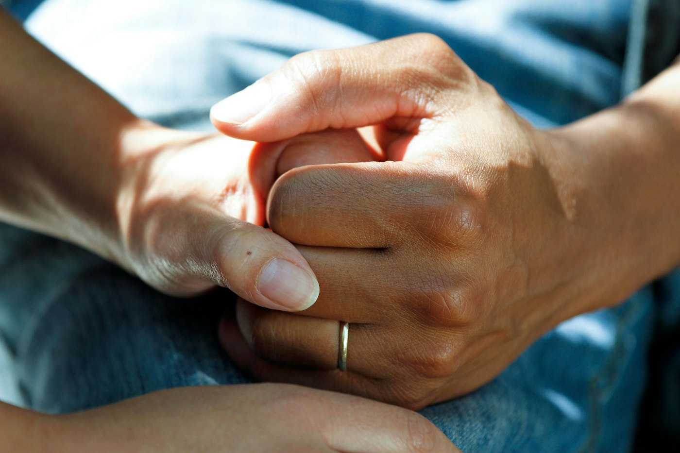 A clinician gently holding a patient's hands
