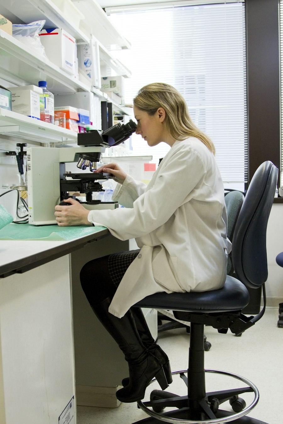 A scientist working at a microscope in the lab