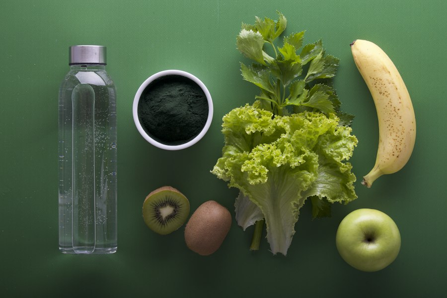 Fresh vegetables, fruit and water arranged on a green surface